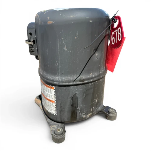 Close-up view of the used Tecumseh AWA2460ZXT 1.5 HP compressor, 3 phase 208-230 volt, showing the black service valve fitting, a red round tag numbered "678", and an orange "CAUTION: Under Pressure" tag with the Nitrogen box checked.