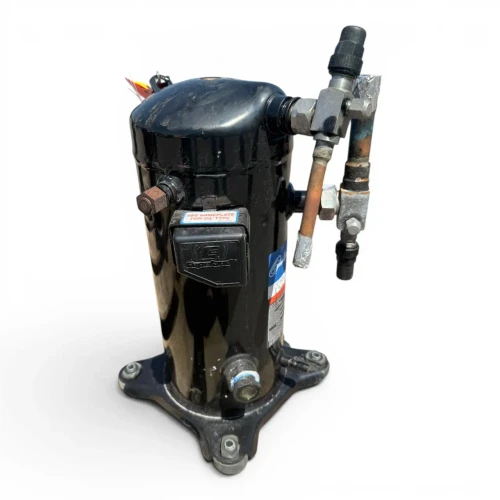 Front-right view of a used Copeland ZF09-K4E-TF5 3 HP scroll compressor, 3 phase 208-230 volt, showing the valve manifold with a foil-wrapped copper line and red/yellow inventory tags at the top.