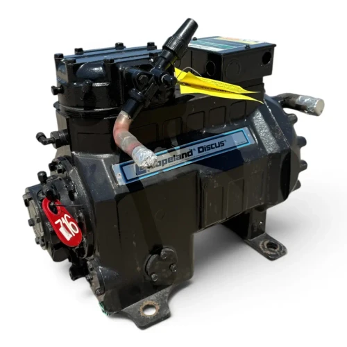 Front-left view of the used Copeland 2DC3-050E-TFC 5 HP Discus compressor (3 phase, 208-230 volt) rotated slightly, showing the red "716" tag, a yellow oil-safety-control checklist tag, and the foil-capped elbow fitting near the nameplate.