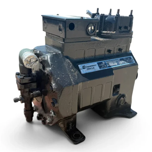 Front view of a used Copeland 2DA3-F23KE-TFD 6 HP Discus compressor, 3 phase 460 volt, showing the Copeland Discus nameplate and a red inventory tag partially visible on the left side.