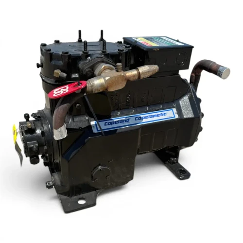 Front view of the used Copeland 3DA3-F28KE-TFD 6 HP compressor showing the "Copeland Discus" rating nameplate with model and serial numbers, a yellow inventory tag, and the copper suction line entering the housing.