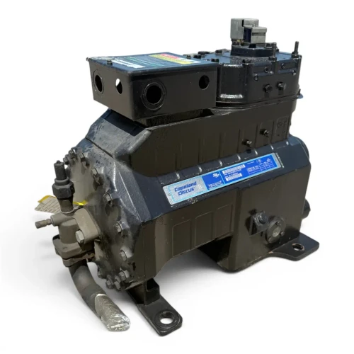 Front view of a used Copeland 3DAD-F28KE-TFC 6 HP compressor (3 phase 208-230 volt), a black cast housing with the "Copeland Discus" nameplate, a black terminal box with two conduit knockouts, and a foil-wrapped fitting on the left side.