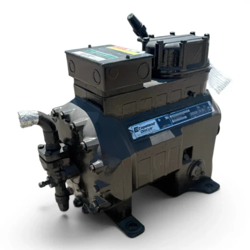 Front-on view of the used Copeland 2DA3-075E-TFC 7.5 HP compressor, 3 phase 208-230 volt, with a red round inventory tag and a yellow "add oil to compressor" tag hanging from the top discharge valve.