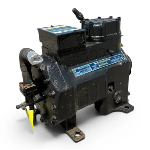 Three-quarter front-right view of the used Copeland 2DL3-075E-TFD 7.5 HP compressor, 3 phase 460 volt, showing a red round inventory tag hanging from the top valve alongside a yellow oil-reminder tag.
