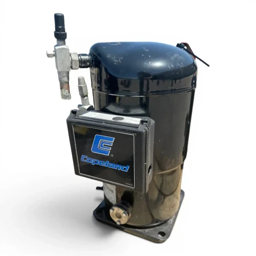 Front-left view of the used Copeland ZS56K4E-TWD 7.5 HP compressor, 3 phase 460 volt, showing the black Copeland-badged terminal cover, a foil-wrapped copper suction stub, and a schrader valve fitting on top of the black dome.