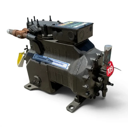 Front-left view of a used Copeland 3DF3-F40K0-TFD 9 HP Copelametic compressor, 3 phase 460 volt, showing the silver "Copeland Copelametic" nameplate, a rusty two-tone copper suction fitting, the black terminal box with a multicolor caution sticker, and a red inventory tag reading "709."