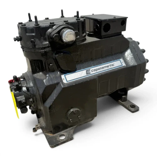 Front-left view of a used Copeland 3DS3A-100E-TFC 10 HP compressor, 3 phase 208-230 volt, showing the silver "Copeland Copelametic" cast nameplate, the black terminal box, and a small tag near the top valve.
