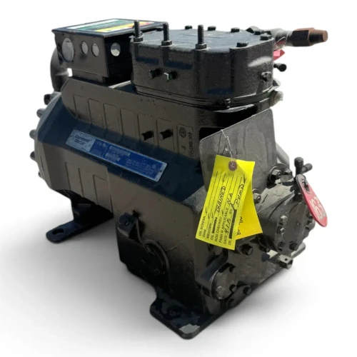 Front-angled view of the used Copeland 3DS4S-12ML-TFC 10 HP compressor, 3 phase 208-230 volt, showing a rusty copper elbow fitting at the top right along with the yellow and red service tags.
