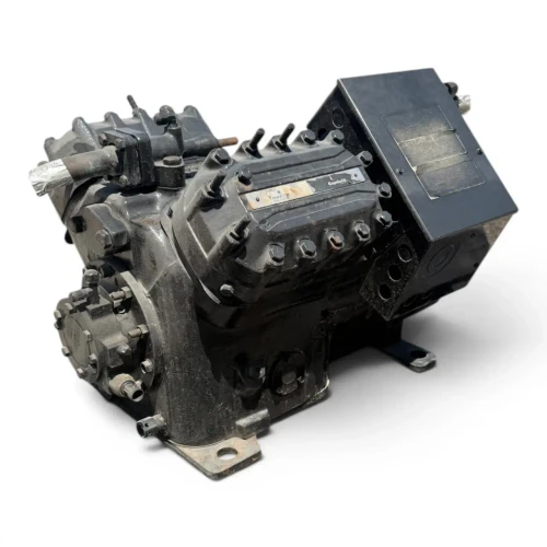 Side view of the used Copeland 4DA3-F47KE-TSK 10 HP compressor, 3 phase dual voltage, showing the bolted valve covers, terminal box, and mounting feet of the open-drive reciprocating body.