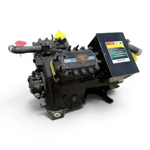 Front-angled view of the used Copeland 4DA3-F47KL-TSK 10 HP compressor, 3 phase dual voltage, showing the red inventory tag and yellow service tag beside the bolted cylinder head.