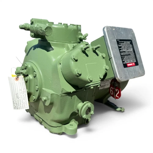 Front view of the used Carlyle 06DR3376DC367 10 HP compressor showing a foil-wrapped copper suction line on the left side, the terminal box at upper right, and the green cast housing with visible mounting feet.