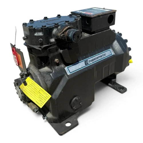 Straight-on front view of the used Copeland 3DF4-R15ME-TFC 12 HP compressor, showing the "Copeland Discus" nameplate with spec data, an olive-toned housing, and a yellow "Add Oil to Compressor" tag on the front casting.