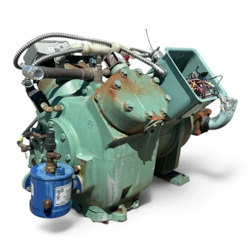 Front-right three-quarter view of the used Carlyle 06EZ450370 15 HP compressor (3 phase Dual Voltage), showing an open terminal box with a tangle of colored control wires, a blue oil-safety switch canister labeled "S-9130" at the left, and a rust-streaked coupling flange with a foil-wrapped stub at the right.
