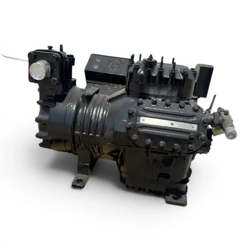 Angled front-right view of the used Copeland 6DF3-F11ME-TSK 30 HP compressor, 3 phase Dual Voltage, black finish, showing a small CoreSense electronic module mounted on the right side, an "Attention" caution label on the cylinder head, and a foil-capped service valve.