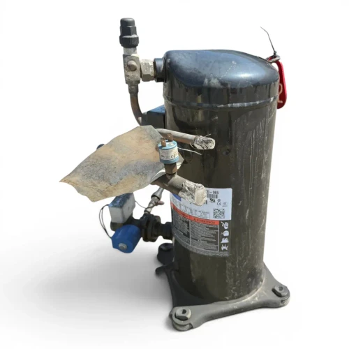 Front view of a used Copeland ZB45KCE-TFD 6 HP scroll compressor (3 phase 460 volt), a black cylindrical shell with a red round "122" inventory tag, a side discharge valve, and a copper fitting with a yellow tag on the left.