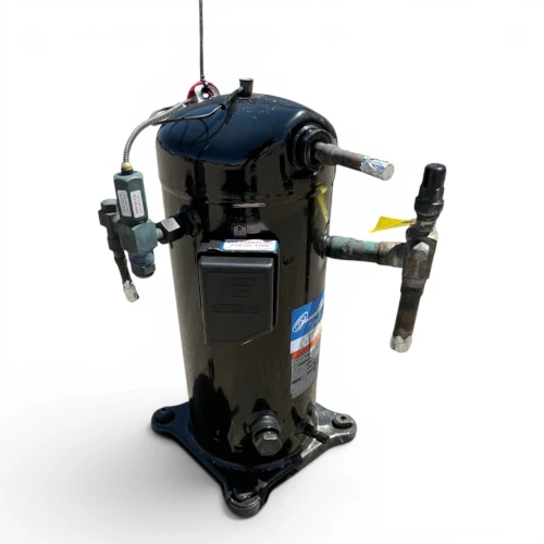 Front-left view of a used Copeland ZF18K4E-TF5 6 HP scroll compressor (3 phase 208-230 volt), a black cylindrical shell with a "ZF18K4E-TF5" model label, a yellow warning tag, and a green-oxidized copper service valve.