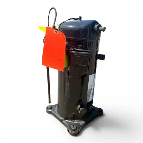 Front view of a used Copeland ZF18K4E-TF5 6 HP compressor, 3 phase 208-230 volt, with a weathered dark gray-black finish, a red round tag numbered "613" and a yellow "Add Oil To Compressor" tag hanging from the top, and a copper stub with brass fitting and orange/yellow flag tags on the right side above the cast mounting base.