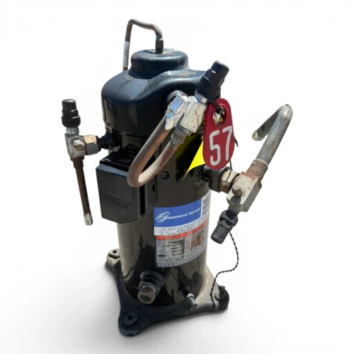 Front view of a used Copeland ZFD18KVE-TF5 6 HP scroll compressor (3 phase 208-230 volt), showing a red inventory tag numbered "57", the Copeland Scroll rating label, and service valves on both sides with a copper loop at the top.