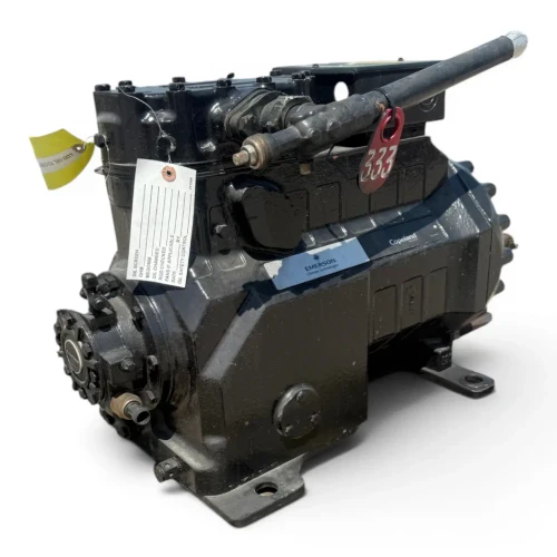 Front-right three-quarter view of the used Copeland 3DS3-R17ME-TFC 15 HP compressor, showing the "Copeland Discus" nameplate with visible spec table, a curved copper suction line at lower left, and a yellow tag on the terminal box.
