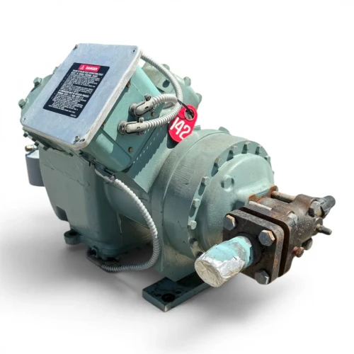 Front view of the used Carlyle 06EZ750-37ARP 15 HP compressor - 12050 (3 phase Dual Voltage), showing the stamped marking "WS 120402" on the mint-green cylinder head, a small teal control housing with an electrical connector at the top, and the red "142" tag hanging near the valve.