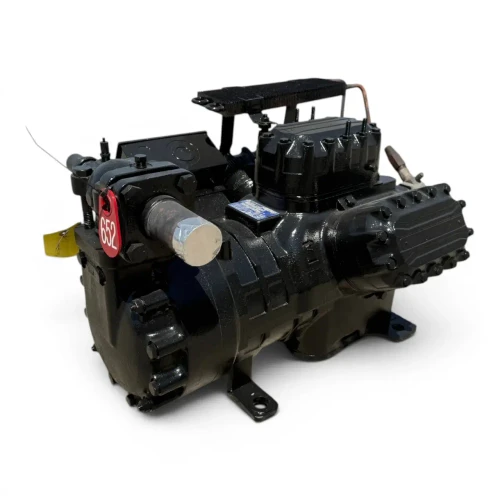 Angled front-right view of the used Copeland 6DL3-F93KE-TSK 27 HP compressor, 3 phase Dual Voltage, showing a foil-capped service valve with an attached ball valve fitting, copper crankcase heater tubing, and a blue data label on the cylinder head.