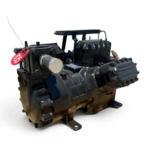 Angled front-right view of the used Copeland 6DL3-F93KE-TSK 27 HP compressor, 3 phase Dual Voltage, showing the crankcase heater assembly, a foil-capped service valve with a ball valve fitting, and a red inventory tag on the far right.