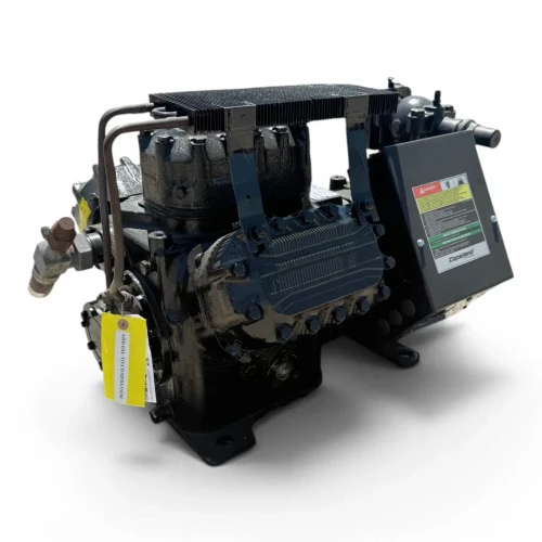 Angled front-left view of the used Copeland 6DL3-F93KE-TSK 27 HP compressor, 3 phase Dual Voltage, showing a foil-capped left valve fitting, a foil-capped right service valve with a rust-toned ball valve, and coiled wire lead.