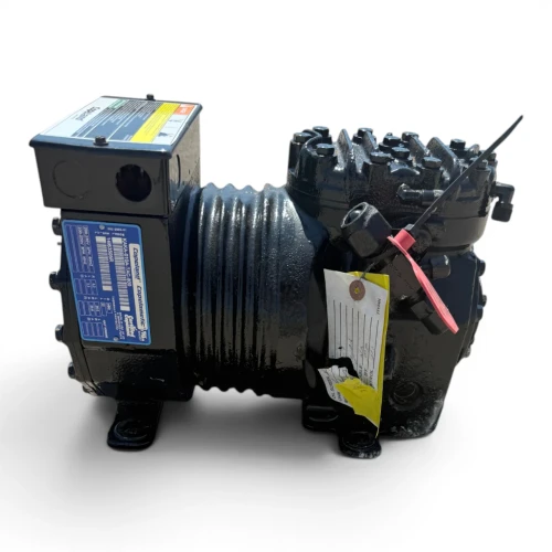 Front-right view of a used Copeland KAKA-010A-TAC 1 HP compressor - 11828 (3 phase 208-230 volt), a semi-hermetic reciprocating compressor with a red inventory tag "690," a yellow "ADD OIL TO COMPRESSOR" tag, and a foil-wrapped process tube at the top.