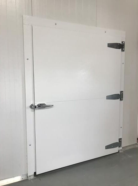 White door with stainless steel hinges and latch as part of a walk-in cooler or freezer