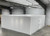 Large white drive-in cooler with hinged door and insulated panel walls
