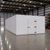 Large white drive-in freezer with hinged door and insulated panel walls