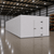 Large white drive-in freezer with hinged door and insulated panel walls