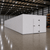 Large white drive-in freezer with hinged door and insulated panel walls