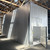 Drive-in freezer with floor outside front left side photo with door open.