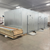 Silver galvanized walk-in freezer with floor exterior front left view.