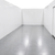 White walk-in cooler unit with closed hinged door, featuring insulated panel walls inside view