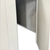 White walk-in cooler unit with closed hinged door, featuring insulated panel wall inside view