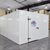 White walk-in cooler unit with closed hinged door, featuring insulated panel walls front side view