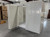 White walk-in commercial freezer with an open door revealing a textured floor