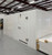 White walk-in commercial freezer with ceiling panels next to it