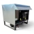 Front-left view of a used Hussmann HICA0304SLKGF condensing unit #570, a self-contained indoor unit with an angled roof canopy over an open equipment frame and inventory tag #570.