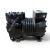 Left-side view of the used Copeland KAJA-011E-TAC 1 HP compressor, showing the bolted cylinder head, service valve fittings, and a stamped serial number on the base casting, with no hang-tags visible on this side.
