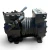 Front-angled view of the used Copeland KAKA-010A-TAC 1 HP compressor, showing the bolted valve plate with the Copeland "C" emblem, foil-wrapped tube stubs, and a cable-tie strand on top of the cylinder head.