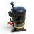 Front-right view of the used Copeland CS10K6E-TFD 1.5 HP compressor, showing a black elbow service valve fitting at the top with a white paper tag, and a red inventory tag "213" hanging from a cable tie near the dome.