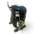 Front-left view of the used Copeland CR18K6-PFV 1.5 HP compressor, showing a bent copper service line at top left, a "WARNING - Turn power off before removing" label with a blue terminal plug icon, and a coiled blue/yellow ground wire at the base.