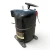 Rear-left angled view of the used Copeland CRA1-0150PFV 1.5 HP compressor, showing a multilingual "AVERTISSEMENT/WARNUNG/AVERTIR/VORSICHT" warning label on the lower shell, a bent copper stub on the left, and the black terminal box.