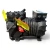 Side view of a used Copeland KALA-016E-TAC 1.5 HP compressor, 3 phase 208-230 volt, black cast-iron housing with a ribbed motor shell, blue Copelametic rating nameplate reading KALA-016E-TAC-220 on the terminal box, and a folded yellow warning tag draped over the top of the cylinder head.