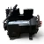 Front three-quarter view of the used Copeland 2DF3-F16KE-TFD 3 HP Discus compressor, 3 phase 460 volt, showing the full rating nameplate with model and serial numbers, bolted cylinder heads, and a yellow "ADD OIL TO COMPRESSOR" tag hanging from the base.
