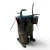 Front view of the used Copeland CRM3-0400-PFV 4 HP compressor (1 phase, 208-230 volt), showing the Copeland-branded terminal box with three wires exiting, a red round inventory tag, a foil-capped copper stub near the base, and an orange warning sticker at lower right.