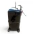 Back view of the used Copeland CRM3-0400-PFV 4 HP compressor (1 phase, 208-230 volt), showing the smooth rear shell with a small white nameplate, the foil-capped copper stub at top, a red inventory tag visible at the upper right edge, and the rusty mid-body seam.